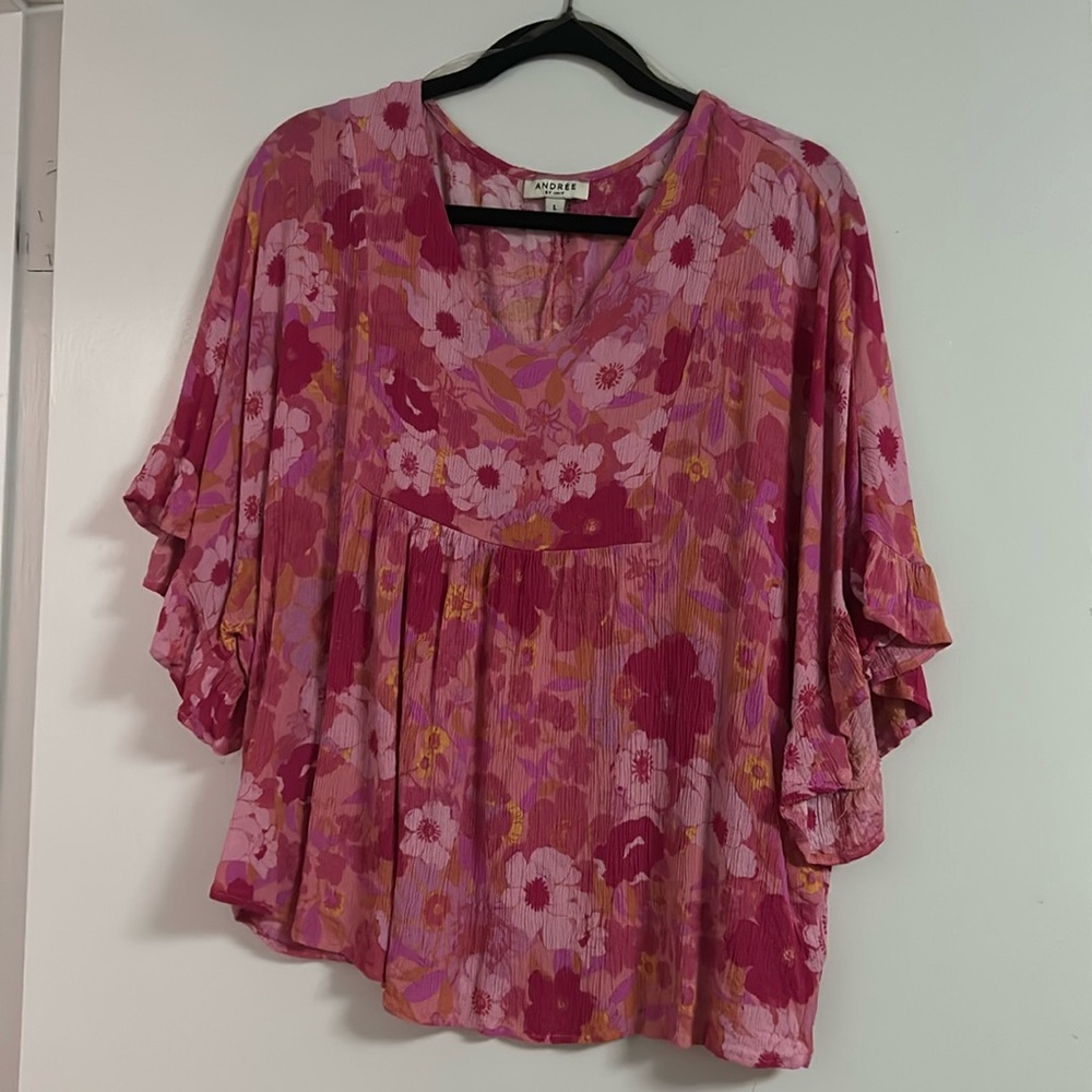 Bought from boutique. Short sleeve with ruffle, with flower design.